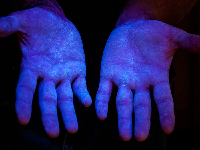 Step 2: Hold hands under UV light to show coverage